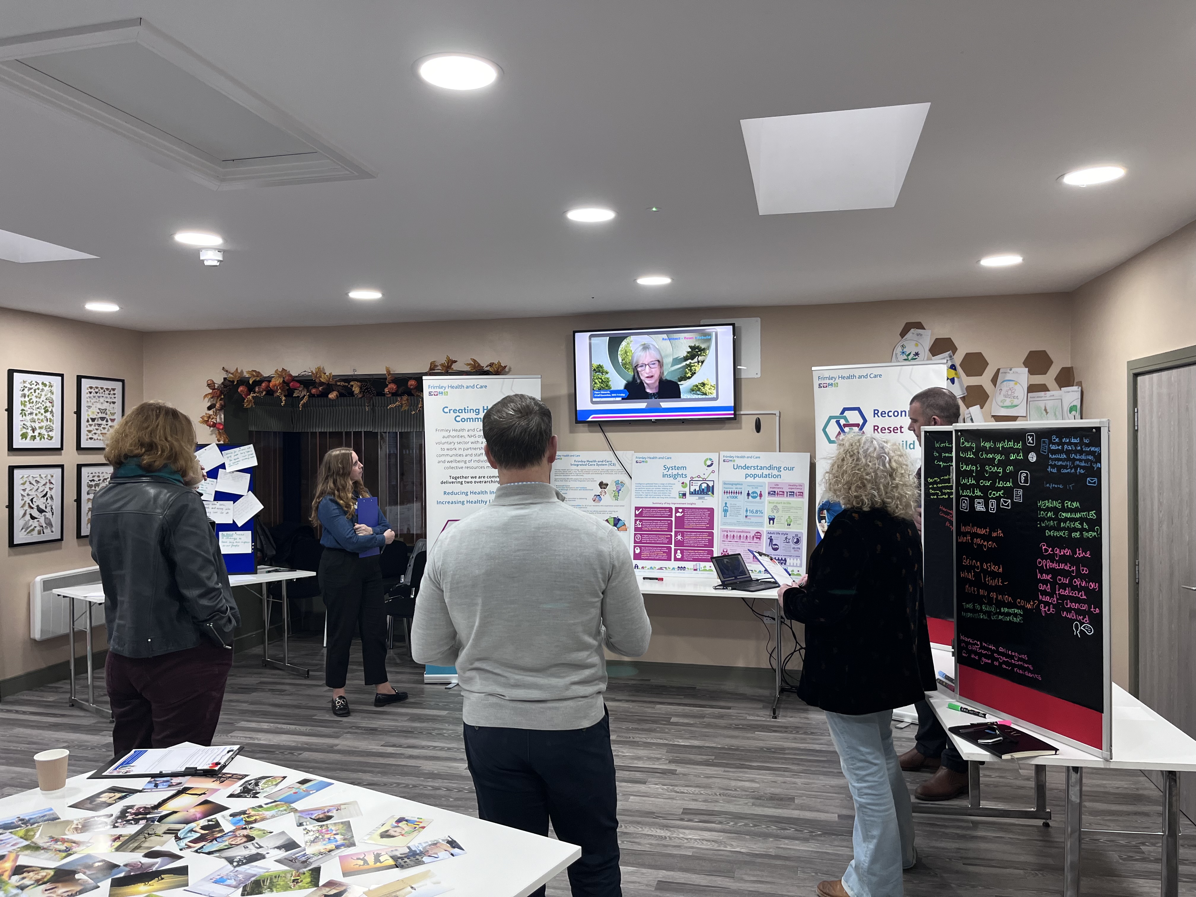 Group of people watching a video of the previous chief exec Fiona Edwards